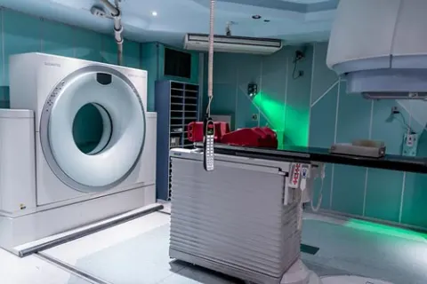 CT scanner and motorised patient table in a hospital imaging suite